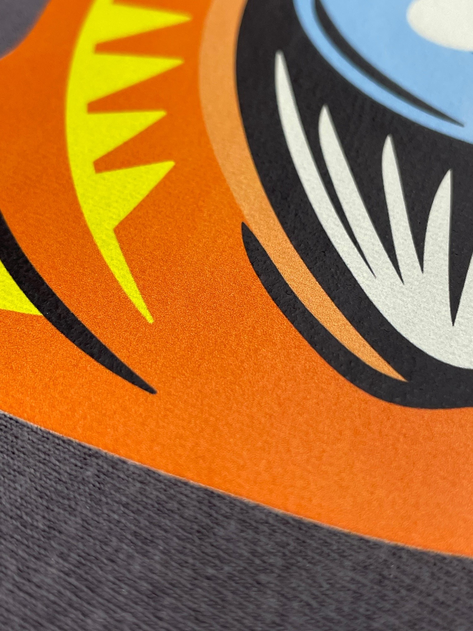A photo of an orange illustration on a shirt to show detail of a direct to film transfer