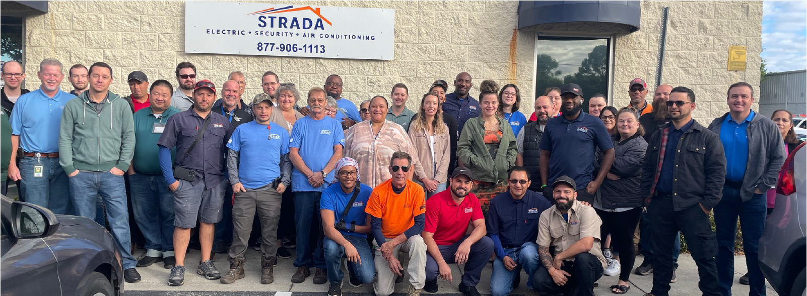 Strada workers in a group outside their building