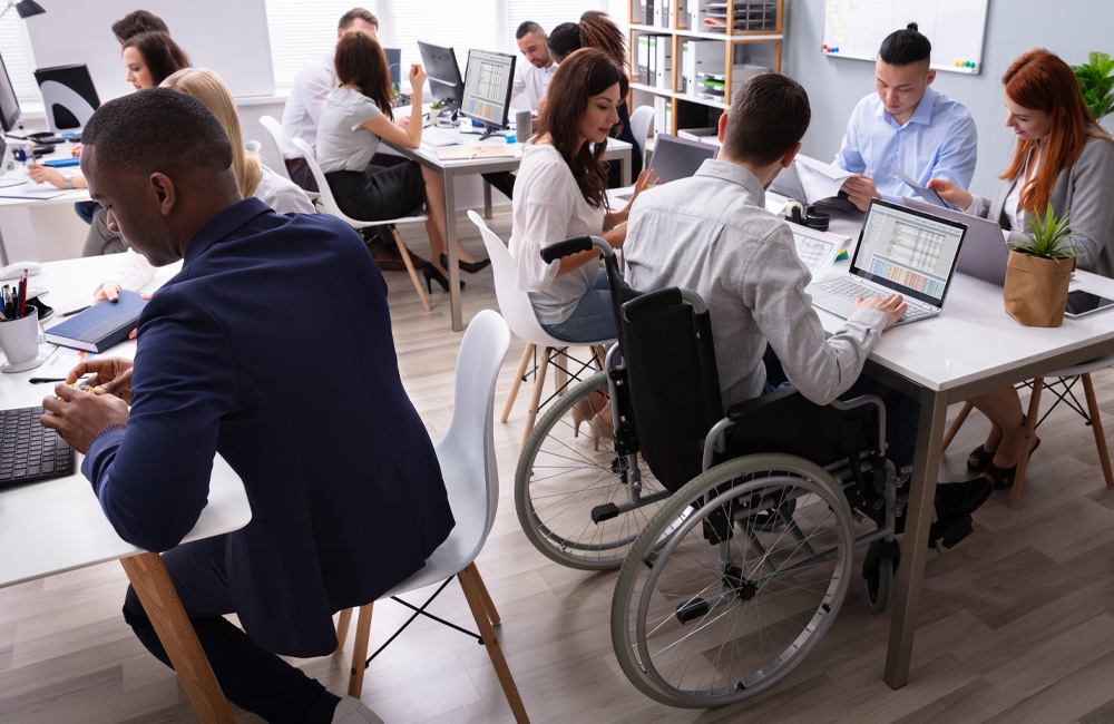 diverse office setting with employees working at computers