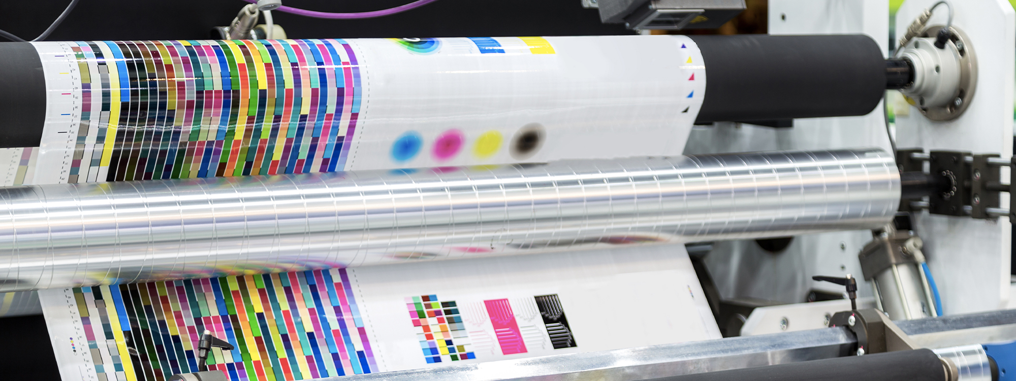 Two people wearing red and coral sweatshirts on a blue background 