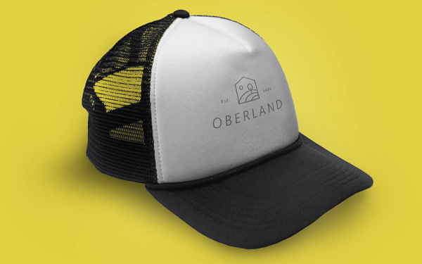 Black and white trucker hat on yellow background